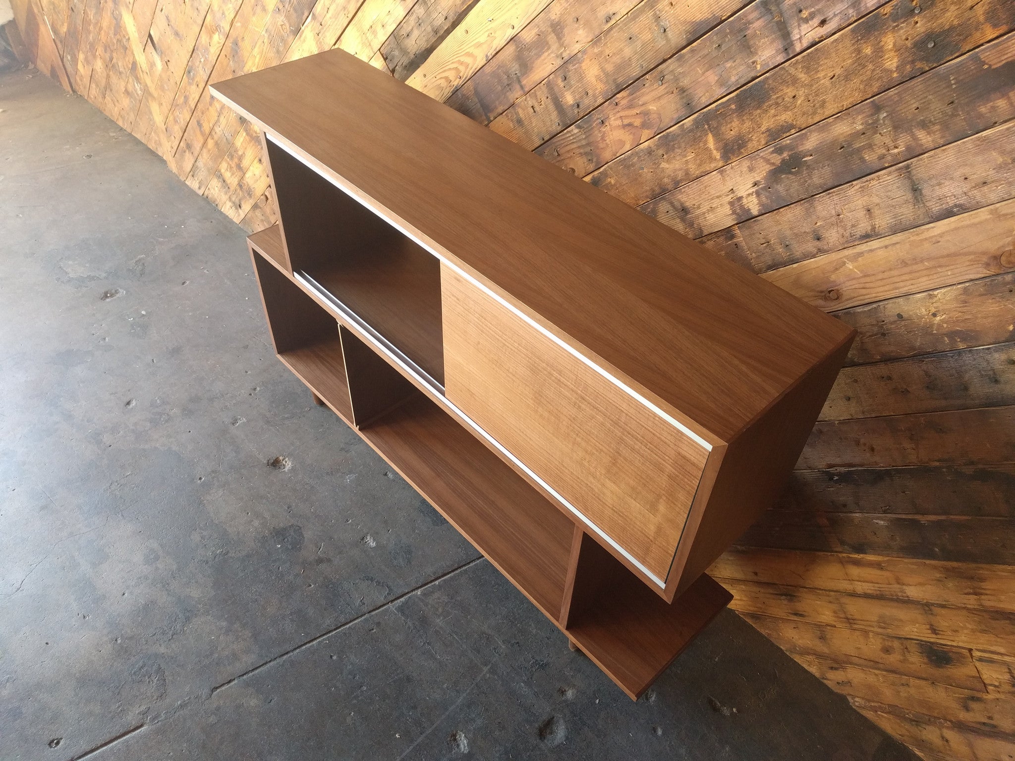 Mid Century Style Custom Walnut Zig Zag Shelf with metal track and sliding door