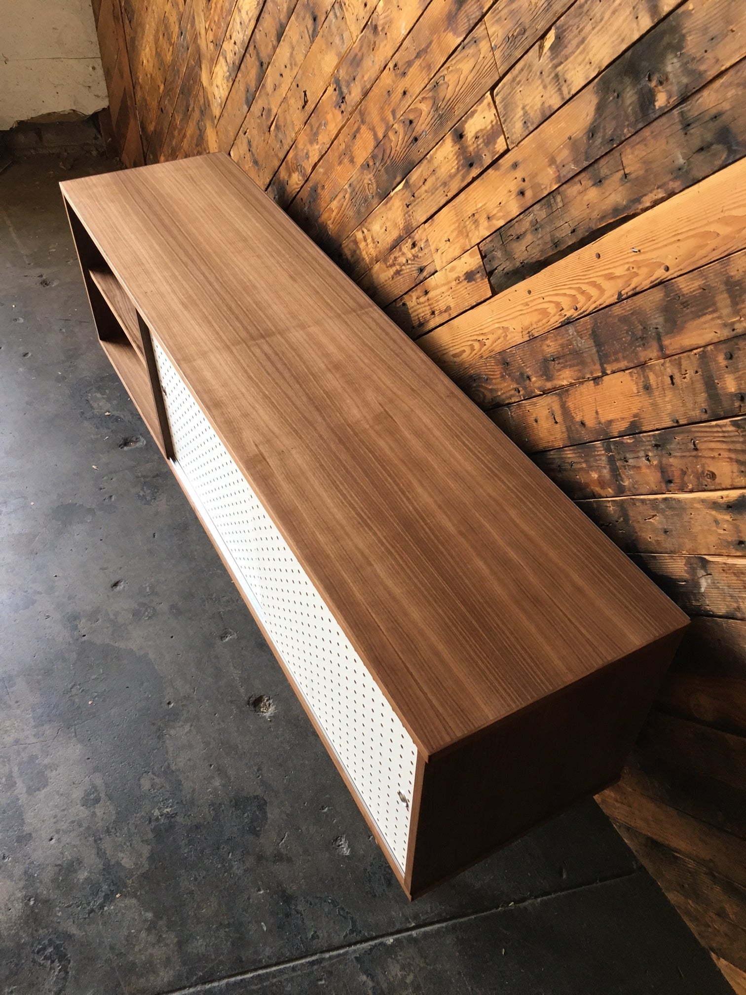 Custom Walnut credenza with perforated doors and metal track, Mid Century Style